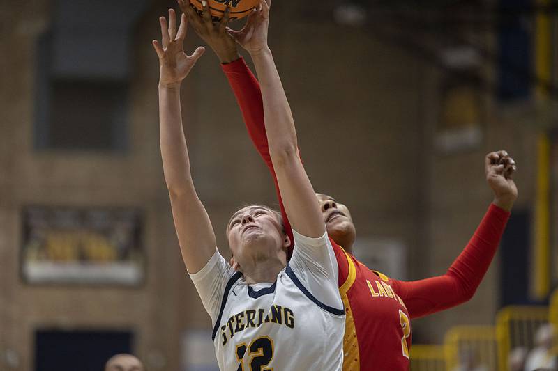 Sterling’s Macie Lofgren goes for a rebound against Rock Island’s Ka'zaria Bell Tuesday, Nov. 25, 2025.