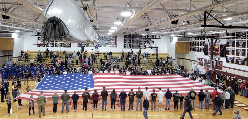 Despite the winter weather, approximately 100 veterans came out to Lockport Township High School’s east campus on Feb. 4 for the school’s annual Veterans Appreciation Night. Veterans and students together held the American flag while everyone who attended sang the National Anthem. Berlands of Joliet donated the large flag.