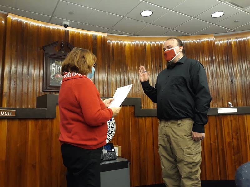 Jacob Dary (right) takes his oath of office Wednesday, Feb. 16, 2022, at Streator City Hall. He becomes the city's newest council member, filling the vacancy left when Tara Bedei was appointed mayor. City Clerk Patricia Henderson (left) reads the oath for Darby to recite.