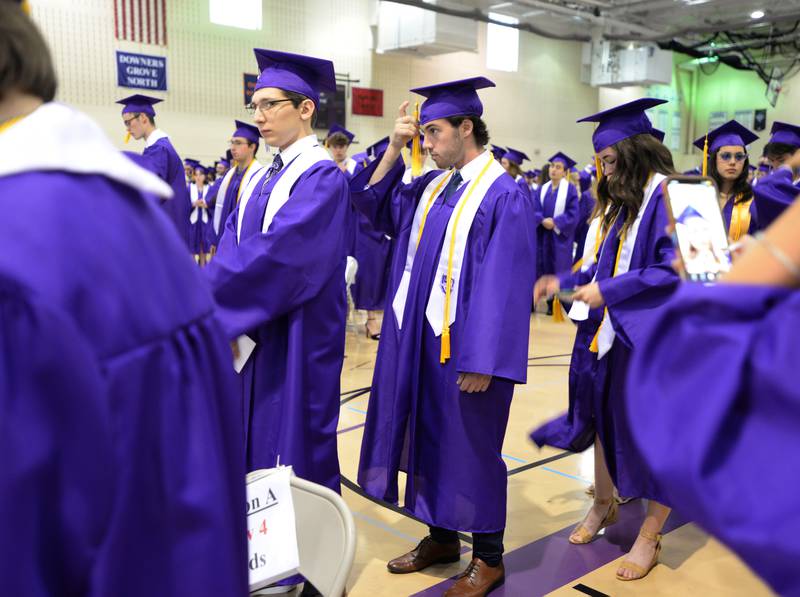 Downers Grove North graduate James Carroll adjusts his tassel prior to the graduation ceremony held Sunday May 21, 2023.