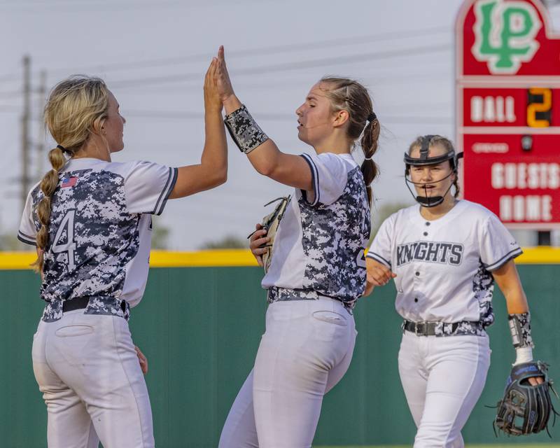 Kaneland team mates celebrate pitcher Brynn Woods getting out of the inning unscathed with runners left in scoring position during the ballgame on April 28, 2025 at the LaSalle Peru High School Sports Complex.