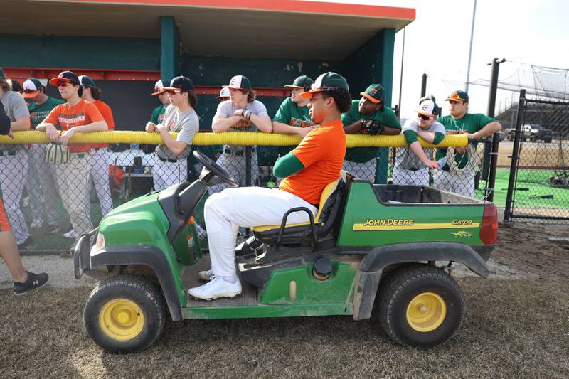 Plainfield East’s Christian Mitchelle sits in the teams four wheeler as coaches talk to the players. Plainfield East holds first outdoor practice. Monday, Mar. 14, 2022, in Plainfield.