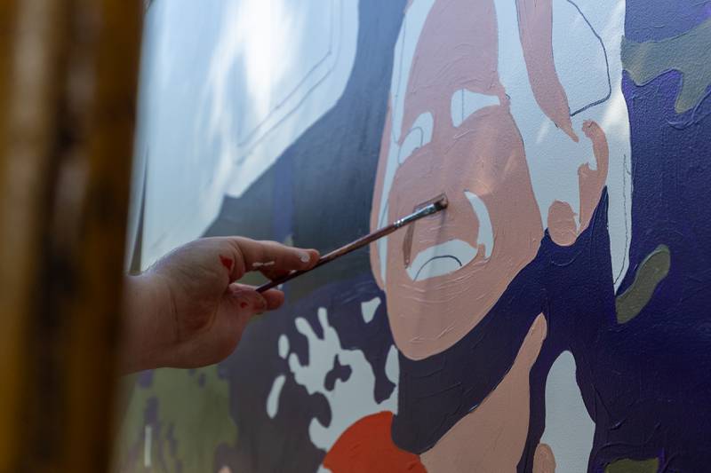 Joe Diaz of the Walldogs paints face on the Streator mural on Thursday, Sept. 11, 2025 at City Park in Streator.