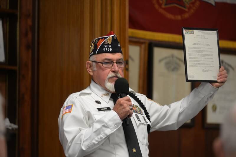 Oregon VFW Post 8739 Commander Bob Coulter holds a proclamation from Oregon Mayor Ken Williams in support of the Post as he speaks at the Veteran Days ceremony on Monday, Nov. 11, 2024 in Oregon. The event was hosted by the VFW Post and the American Legion 97.