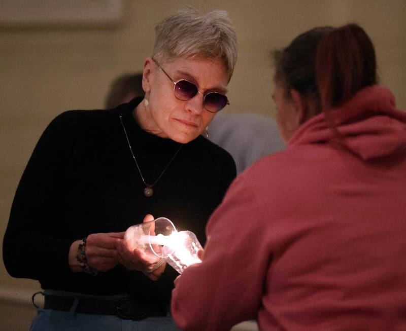 Visitors light candles Monday, Feb. 2, 2026, during the Vigil for Peace at the First Congregational United Church Of Christ in DeKalb. The vigil is being held in remembrance of those lost in recent ICE related shootings and to show solidarity with the people of Minnesota.
