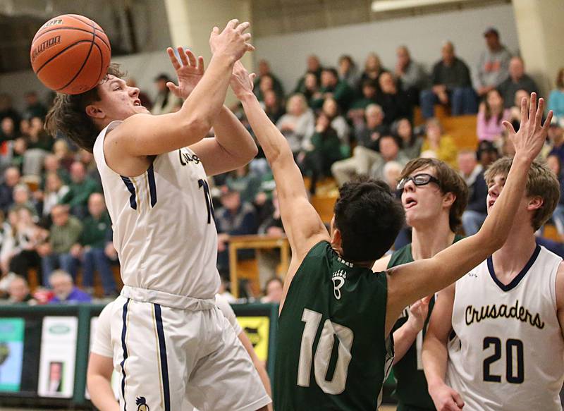 Marquette's Alex Graham looses control of the ball as he runs into the lane while St. Bede's Isaiah Hart defends in the Class 1A Regional semifinal on Wednesday, Feb. 22, 2023 at Midland High School.