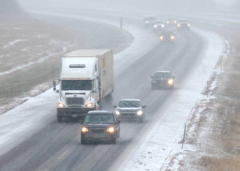 Vehicles travel westbound on Interstate 88 Saturday, Nov. 29, 2025, through heavy snow.