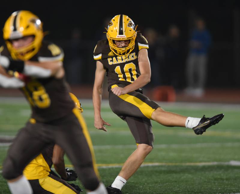 Joe Lewnard/jlewnard@dailyherald.com
Carmel’s Ashton Lutz kicks a field goal to make the score 10-0 over St. Viator during the first quarter of Friday’s game in Mundelein.
