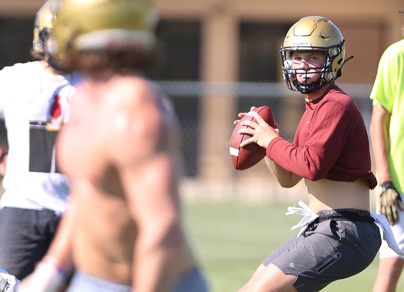 Hiawatha's Cole Brantley (right) looks for receiver Lucas Norvell Wednesday, Aug.10, 2022, during practice at the school in Kirkland.