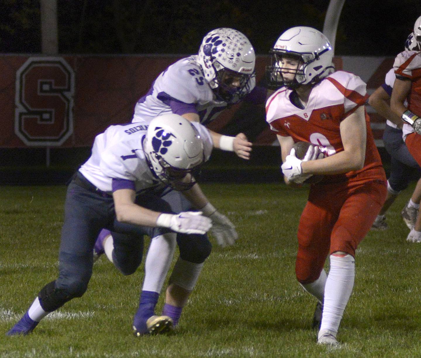 Streator’s Jake Hagie looks for room to run after making a pass reception as the Wilmington defense closes in during 1st quarter Friday at Streator.