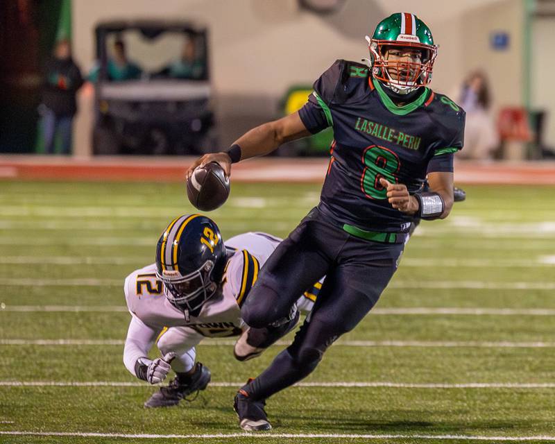 Marion Persich (8) of L-P runs ball as Taylin Abram (12) of O’ Fallon falls behind on Friday, October 24, 2025 at Howard Fellows Stadium in LaSalle.