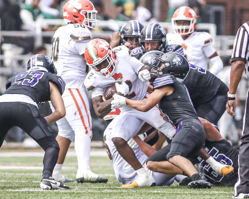 Downers Grove North's Caden Chiarelli (R) brings down Morgan Park's Reggie Gray Jr (2) during football game between Downers Grove North at Morgan Park Saturday, Aug 30, 2025 in Chicago.