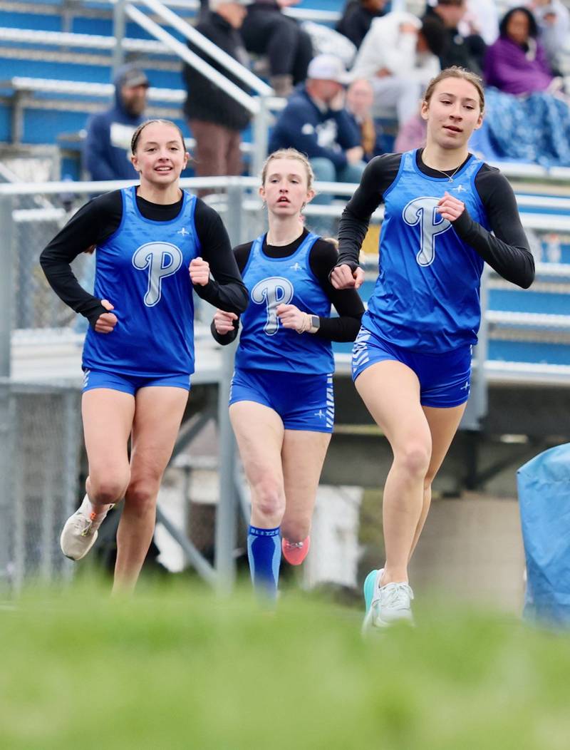 Princeton's Ruby Acker (front), Alexandra Waca and Payton Frueh run the 1,600 meters in Thursday's Howard-Monier Invite.