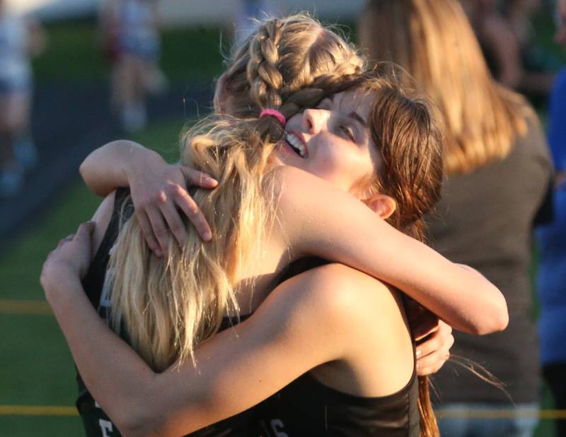 Rock Falls's Kat Scott hugs teammate Hana Ford after winning the 800 meter run during the Ferris Invitational on Monday, April 15, 2024 at Princeton High School.