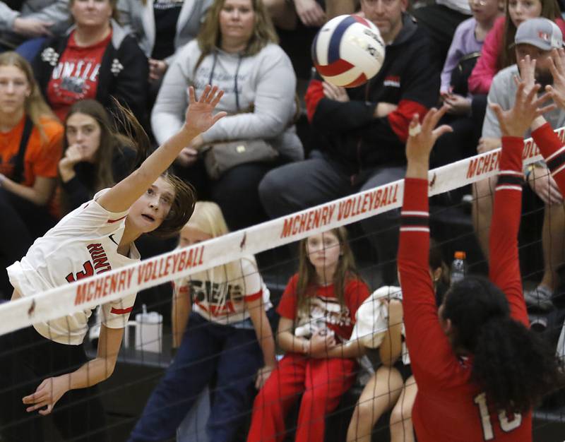 Huntley's Izzy Whitehouse spikes the ball over Mundelein's Sophia Mitry during an IHSA Class 4A McHenry Sectional volleyball match on Tuesday, Nov. 5, 2024, at McHenry High School Freshman Campus.