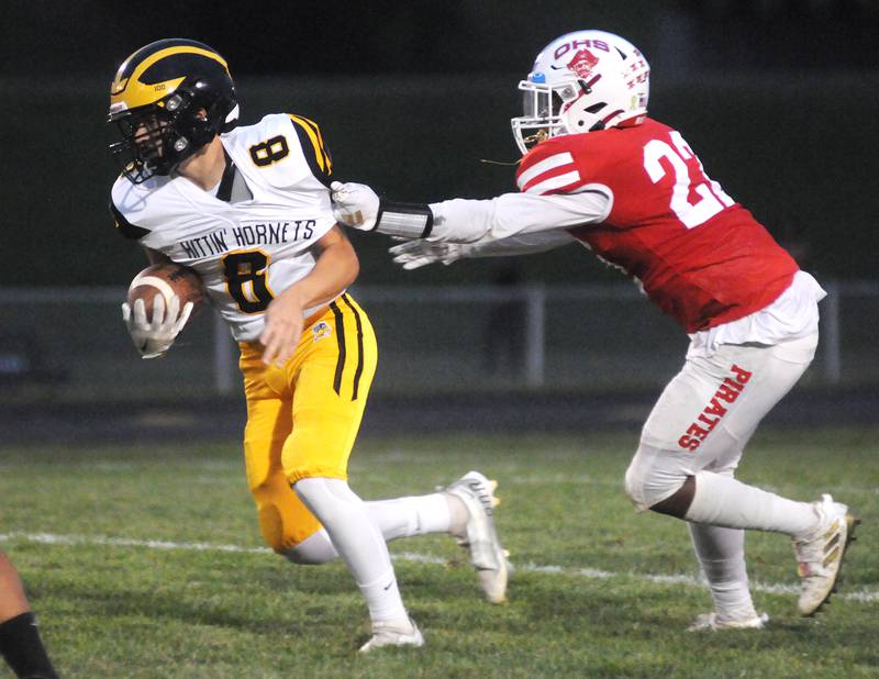 Harvard quarterback Adam Cooke (8) slips away from Ottawa's Tristan Finley at King Field on Friday, Sept. 8, 2023.