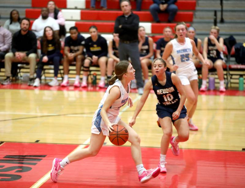 Nazareth’s Mary Bridget Wilson drives toward the basket as she’s pursued by Neuqua Valley’s Zoe Navarro during a game at Hinsdale Central on Thursday, Nov. 16, 2023.