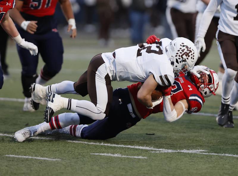 Mt. Carmel's Luca DeRosa (22) runs down St. Rita's Andrew Elwood (23) for a positive gain during the class 7A semi-final playoff game between Mt. Carmel and St. Rita high schools on Saturday, Nov. 23, 2024 in Chicago.
