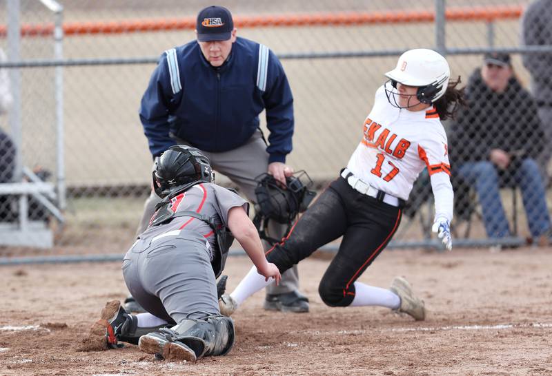 DeKalb’s Isabel Aranda is tagged out trying to score by Rockford Auburn’s Abigail Race during their game Wednesday, March 15, 2023, at DeKalb High School.