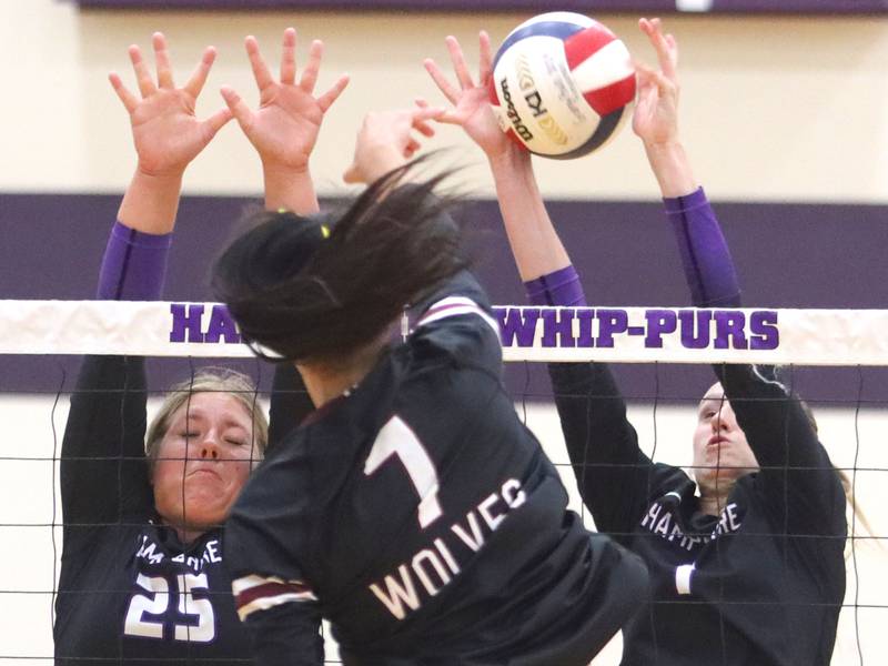 Hampshire’s Hailey Homola, left, and Elizabeth King, right, block against  Prairie Ridge’s Maizy Agnello in varsity girls volleyball at Hampshire High School in Hampshire on Tuesday, Sept. 2, 2025.