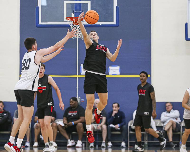 Glenbard East's Michael Nee (4) fights for possession of a loose ball  in their Riverside-Brookfield Shootout basketball game.  June 20, 2025 in Riverside.