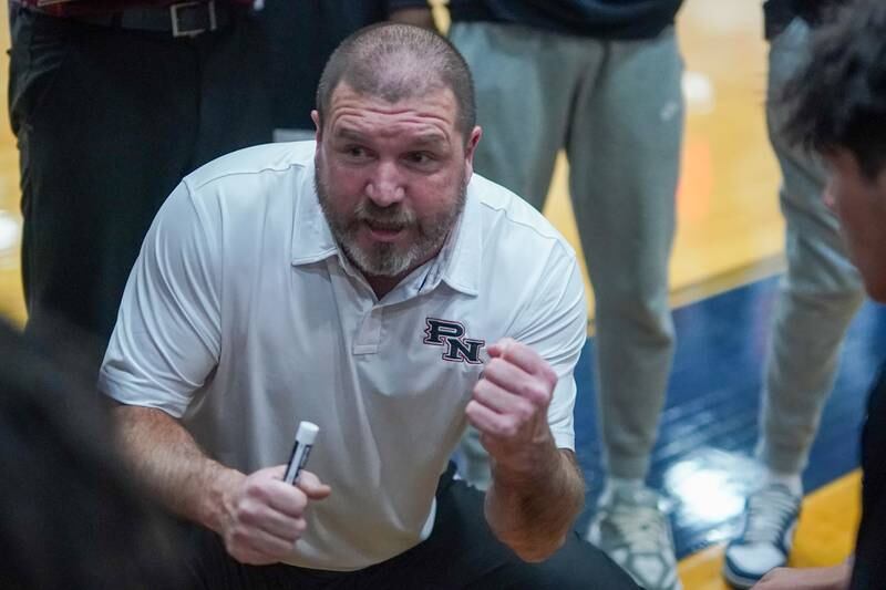 Plainfield North's head coach Robert Krahulik talks to his team during a basketball game against Oswego East at Oswego East High School on Friday, Dec. 6, 2024.
