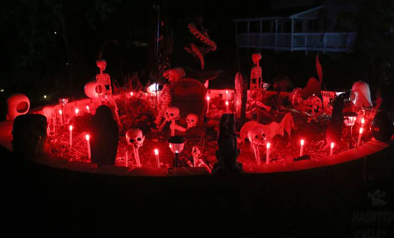A Halloween cemetary glows at home in on Oak Terrace Drive on Thursday, Oct. 17, 2024 in Ottawa.