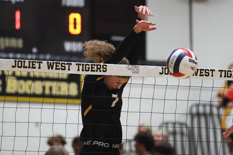 Joliet West’s Gabby Piazza gets the block for set point against Minooka on Tuesday, Sept. 26, 2023 in Joliet.