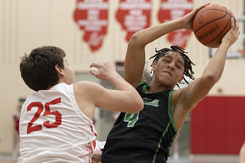 Rock Falls’ Devin Tanton-DeJesus pulls down a rebound against Oregon’s Jackson Caposey Tuesday, Dec. 12, 2023 in Oregon.