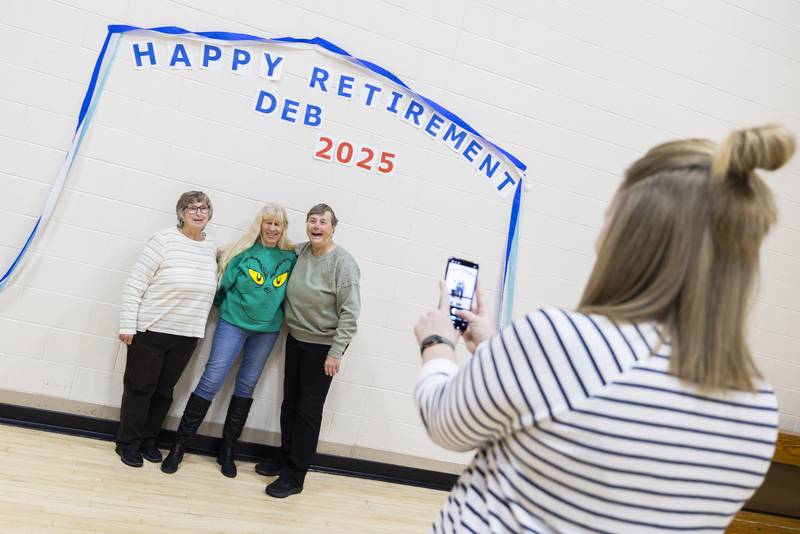 Retiring swim instructor Deb Mortonson (right) has her picture taken with Linda Dowd and Kathy Collinson Wednesday, Dec. 17, 2025, during a party recognizing the many years Mortonson has given to the Y.