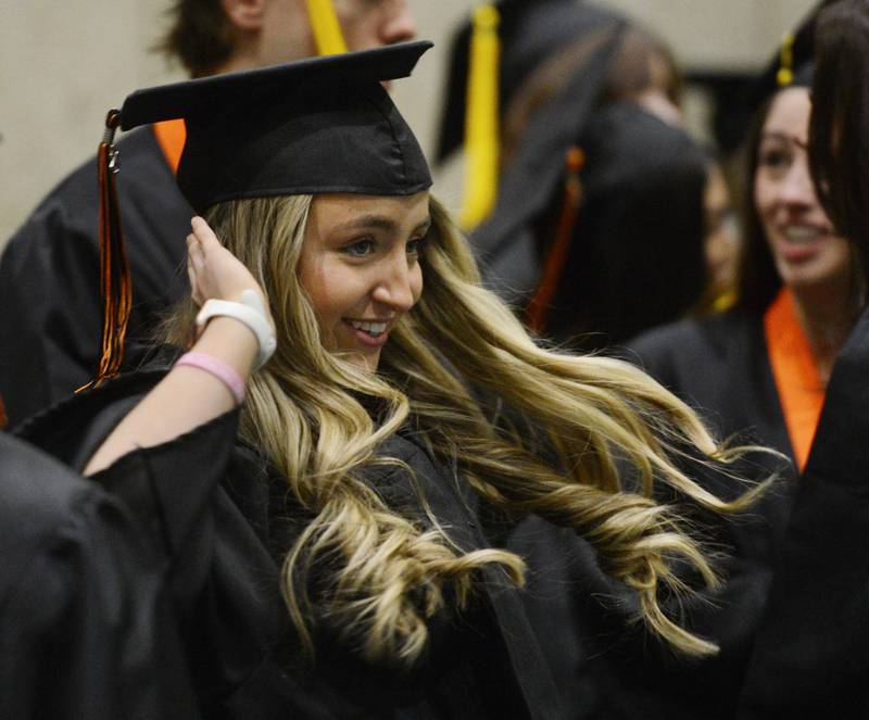 Joe Lewnard/jlewnard@dailyherald.com
Ellie Struthers, a member of the Senior Choir, dances to the beat of the overhead music prior to the start of the Wheaton Warrenville South High School graduation, held at the College of Dupage in Glen Ellyn Saturday.