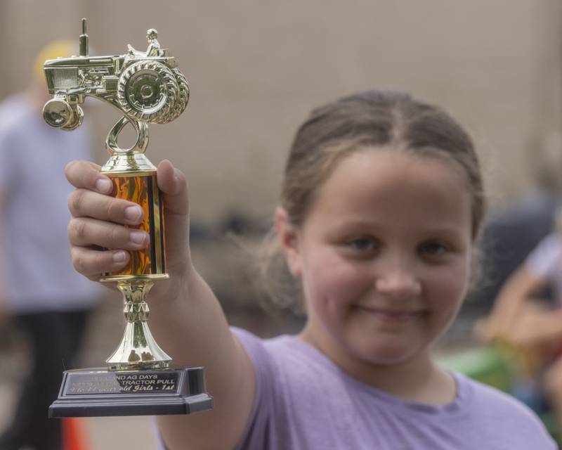Olive Boggs poses with her first place trophy for the girls aged 9 to 11 category in the kiddie tractor pull Saturday, June 15, 2024, during Beef and Ag Days at Soldiers and Sailors Park in Princeton.