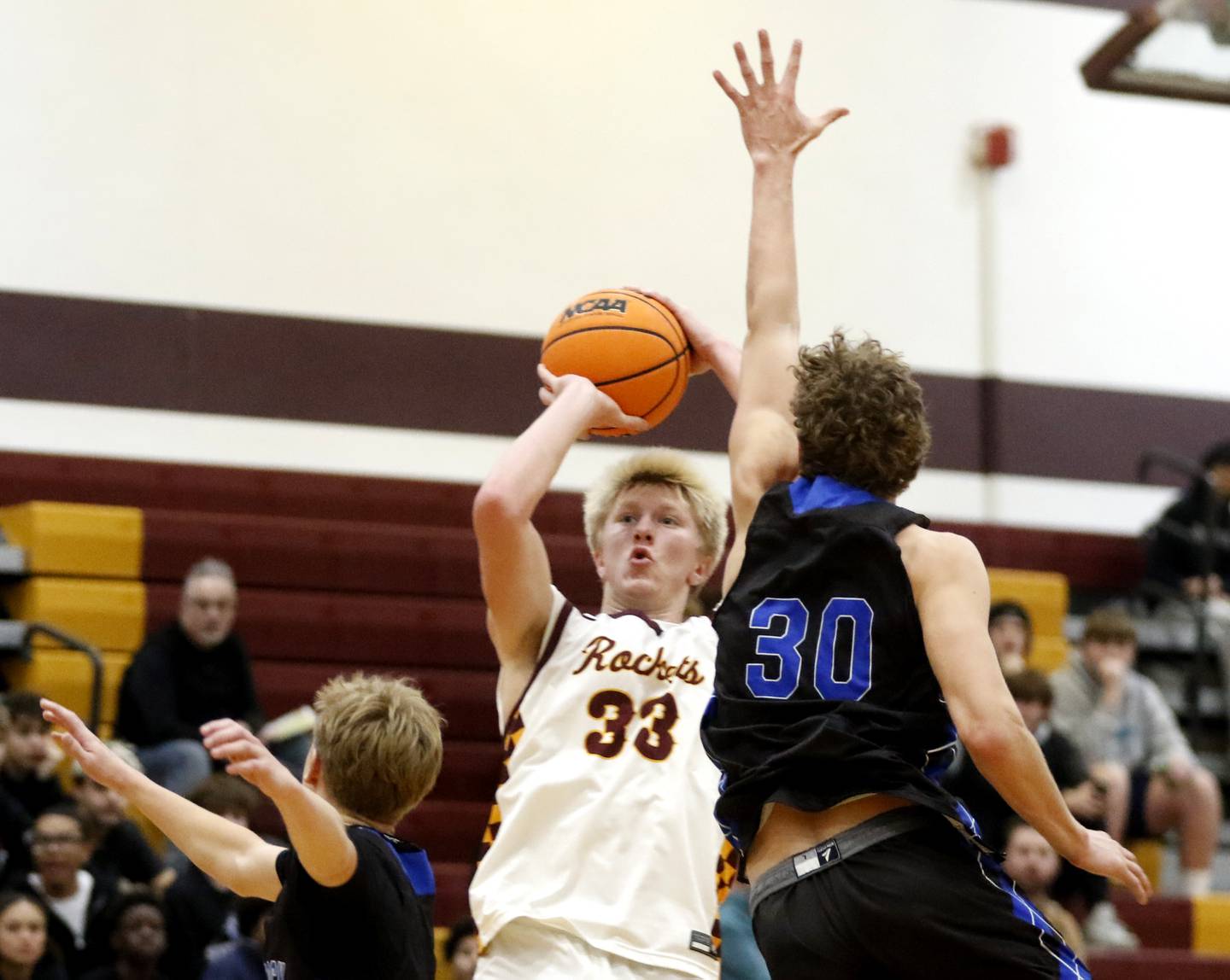 Richmond-Burton's Luke Robinson shoots the ball between Woodstock's Rian Hahn Clifton (left) and Ty Steponitis (right) during a Kishwaukee River Conference boys basketball game on Friay Jan. 9  2026, at Richmond-Burton High School, in Richmond.