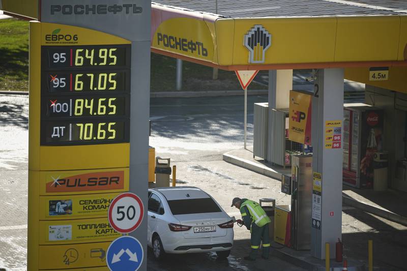 A gas station worker refuels a car in Moscow, Russia, on Aug. 25, 2025. (AP Photo/Pavel Bednyakov)