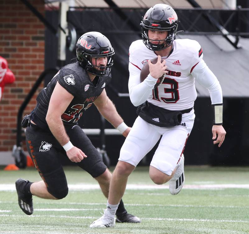 Northern Illinois quarterback Nevan Cremascoli is pursued by Joey Rattin during the Spring Showcase Saturday, April 22, 2023, at Huskie Stadium at NIU in DeKalb.