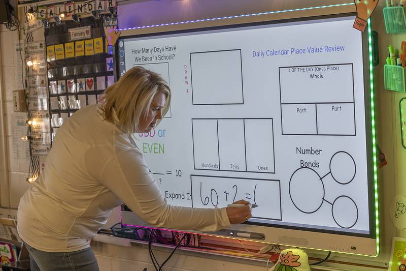 Kristin Ports, first grade teacher at Jefferson School in Sterling, works out a math problem on the smart board Friday, Feb. 7, 2025.