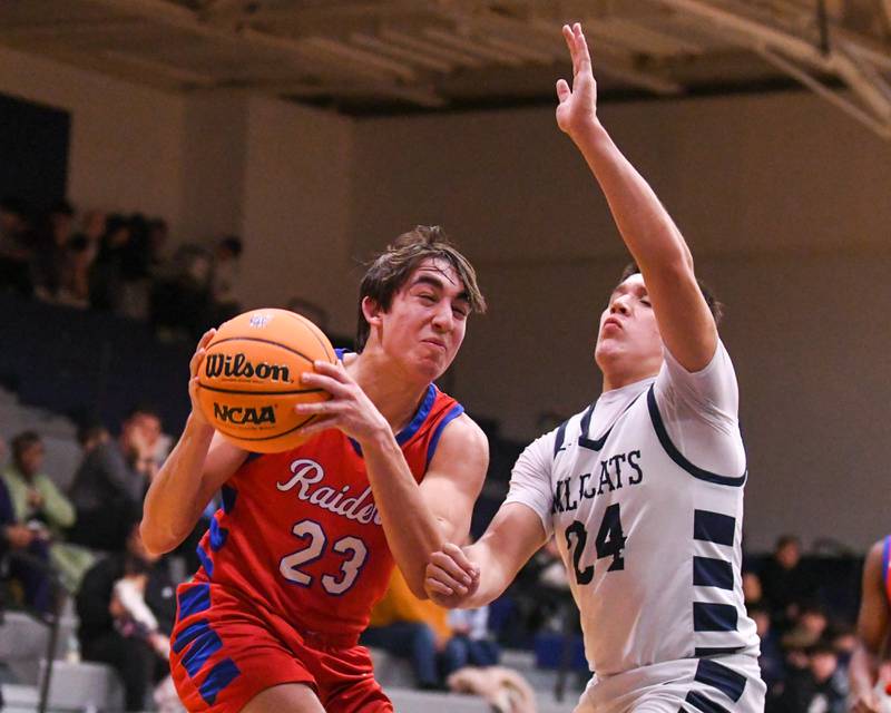Glenbard South's Joey Villa (23) gets a shot off and makes a basket while being defended by West Chicago's Oliver Muñoz (24) during the game on Friday Jan. 3, 2025, held at West Chicago High School.