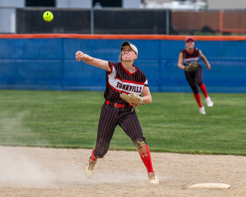 Yorkville's Bella Phillips (11) overthrows the ball to first allowing an Oswego base runner to be safe at first base during the sectional semifinal game on Tuesday June 3, 2025, held at Oswego High School.