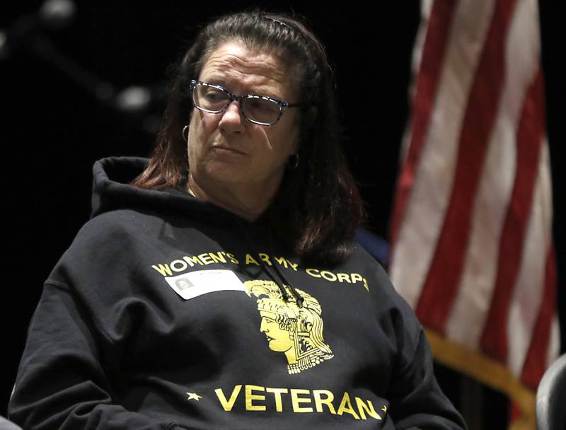 U.S. Army veteran Lolly Peters listens to U.S. Marine World War II veteran Johns Rickerd talk about Iwo Jima during the Veterans Day event on Monday, Nov.11, 2023, at the Upper Campus of McHenry High School.