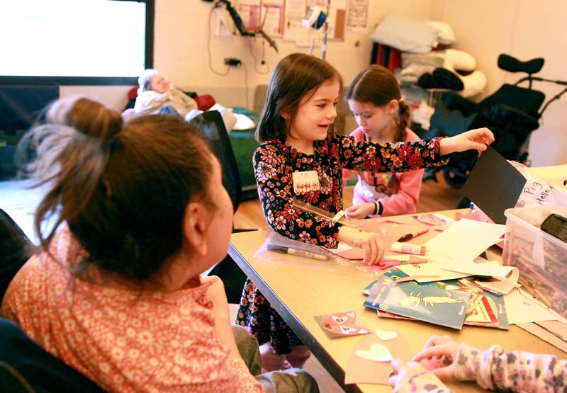 Grace McWayne Elementary School first graders Olivia Seborowski and Savannah Meyer create valentines with Marklund Hyde Center resident Theresa on Wednesday, Feb. 7, 2024.