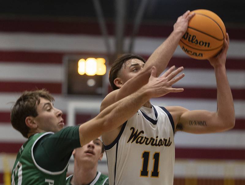 Sterling’s Nico Battaglia goes to the hoop against Alleman’s CJ Carruthers Friday, Dec. 20, 2024, at Sterling High School.