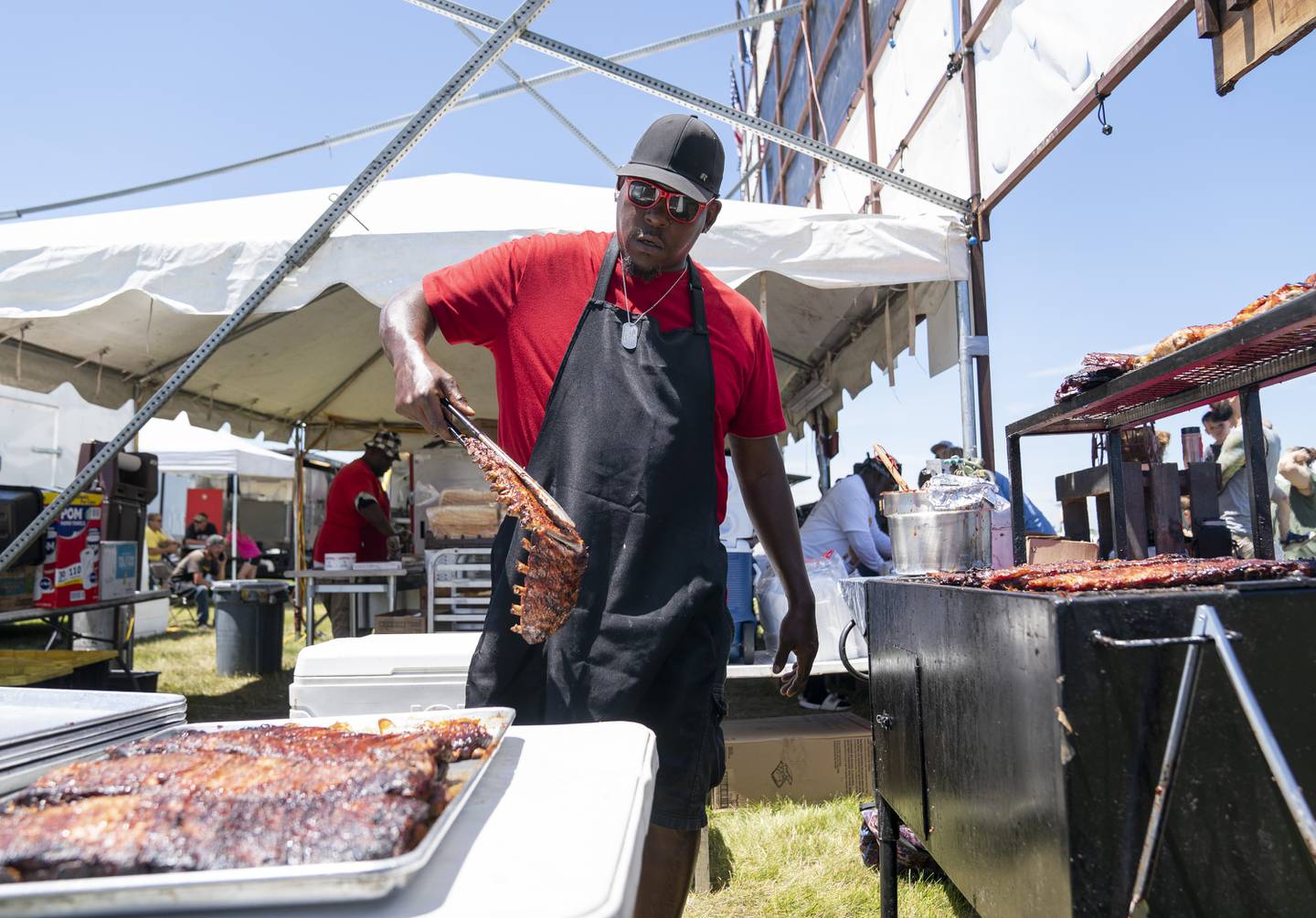"They call me the grillmaster. My favorite part is cooking ribs and satisfying customers." Says Dee Price, of Cleveland, Ohio, as he works the grill with ribs from Cowboys BBQ & Rib Company of Fort Worth, Texas during the final day of the Lake in the Hills Rotary Rockin' Ribfest on Sunday, July 10, 2022 at Sunset Park in Lake in the Hills. The annual festival featuring award winning BBQ and Rib vendors, carnival and live music, ran from July 7-10.