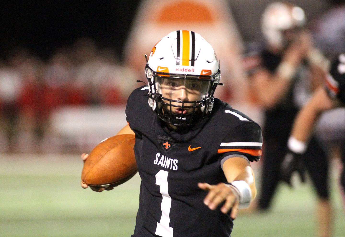 St. Charles East quarterback Lane Robinson keeps the ball during the season opener against Lincoln-Way Central in St. Charles on Friday, Aug. 26, 2022.