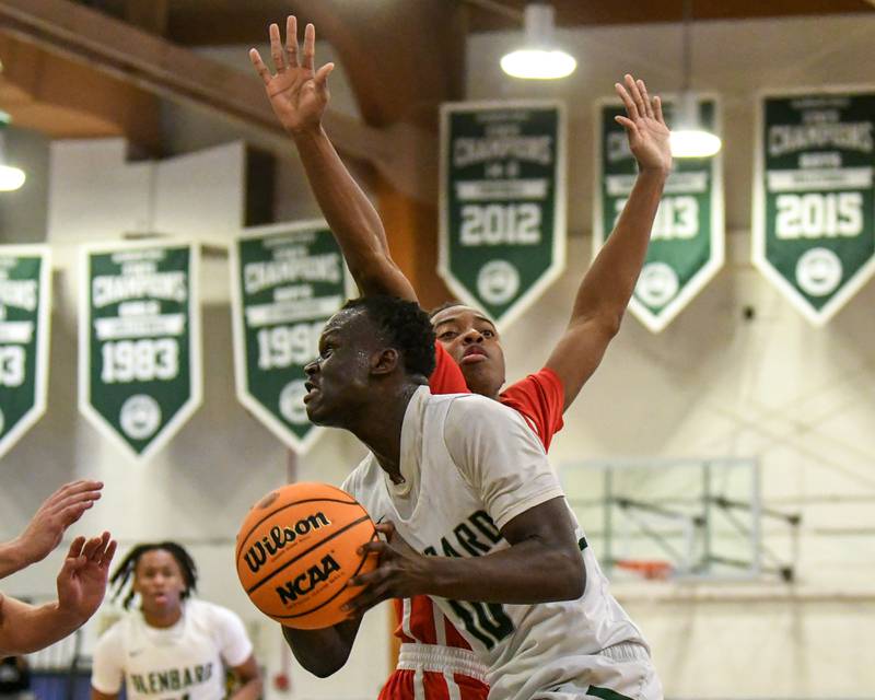 Glenbard West's Josh Abushanab (10) goes up for a shot and gets fouled by Glenbard East's Cameron Bonner (10) on Wednesday Nov. 26, 2025, during the District 87 Thanksgiving Invitational held at Glenbard West High School.