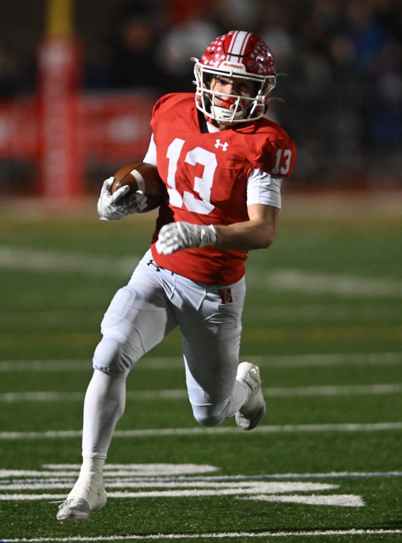 Naperville Central’s Aiden Clark carries the ball for a first-quarter touchdown against York during the Class 8A football state semifinal on Saturday, Nov. 23, 2024 in Naperville.