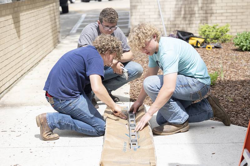 Ag Construction students cut insulation Friday, May 16, 2025, for the mini-food center.