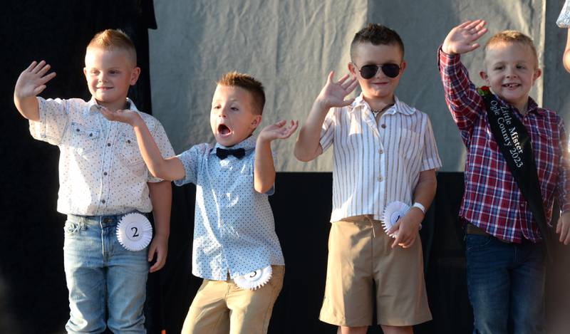 2024 Little Mister contestants Kaiser Hauch, Beau Collins, and Liam Wright wave to the crowd with 2023 Little Mister William Safranek (right) at the Ogle County Fair Pageant on Wednesday, July 31, 2024. Hauch, 5, of Chana (far left) won the competition.