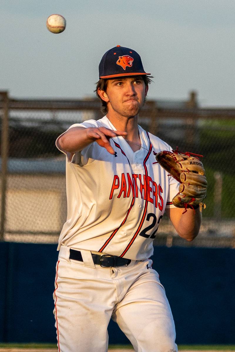 Oswego’s Edward Scaccia (22) fields a Oswego East bunt and throws to first for an out during a baseball game at Oswego High School on Tuesday, May 9, 2023.