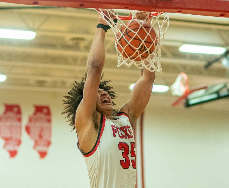 Yorkville's LeBaron Lee (35) dunks the ball off of a fast break against Oswego during the 13th annual Hoops 4 Hope Communities vs. Cancer basketball event at Yorkville High School on Saturday, Jan 28, 2023.