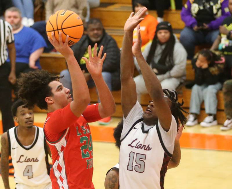 L-P's Marion Persich lets go of a shot in the lane as Peoria's Fenix Foy defends during the Class 3A Sectional semifinal game on Wednesday, March 5, 2025 at Washington High School.